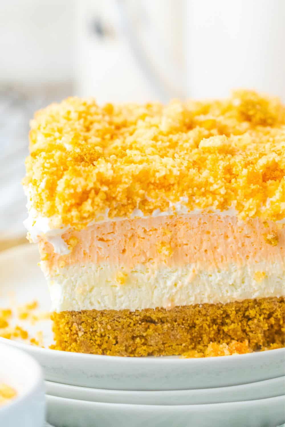 orange jello dessert bar with crunchy golden oreo topping.