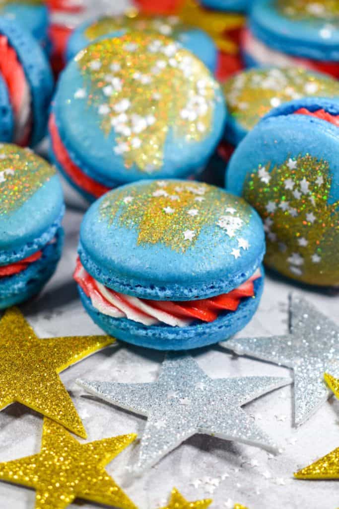 red white and blue macarons with gold dust.