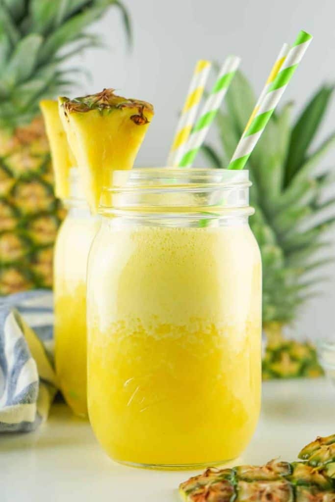 pineapple agua fresca in glass with slice of pineapple.