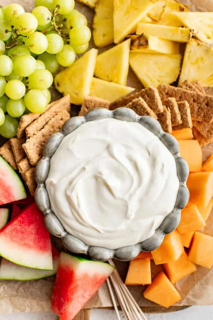 classic cheesecake fruit dip with crackers and chopped fruit.