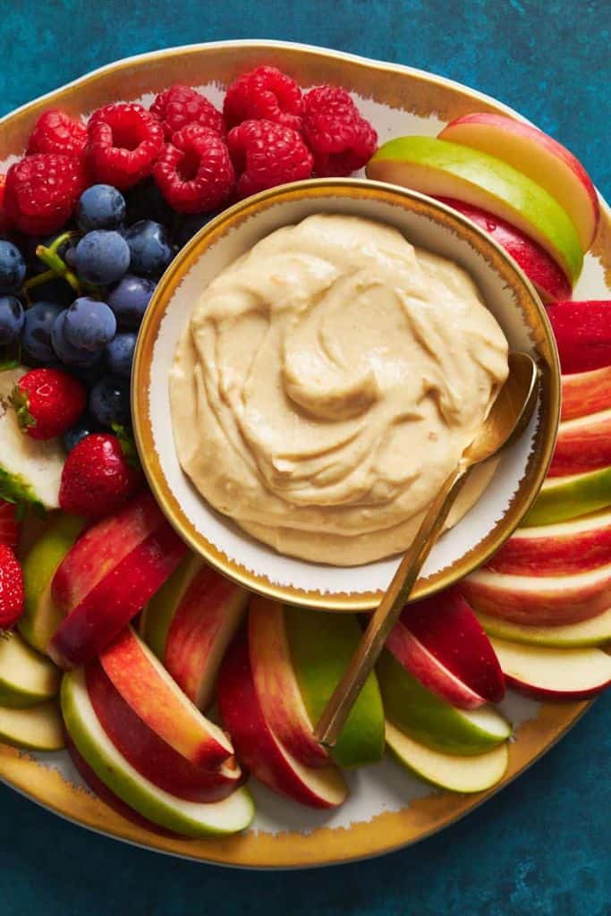 healthy fruit dip in bowl with cut fruit platter.