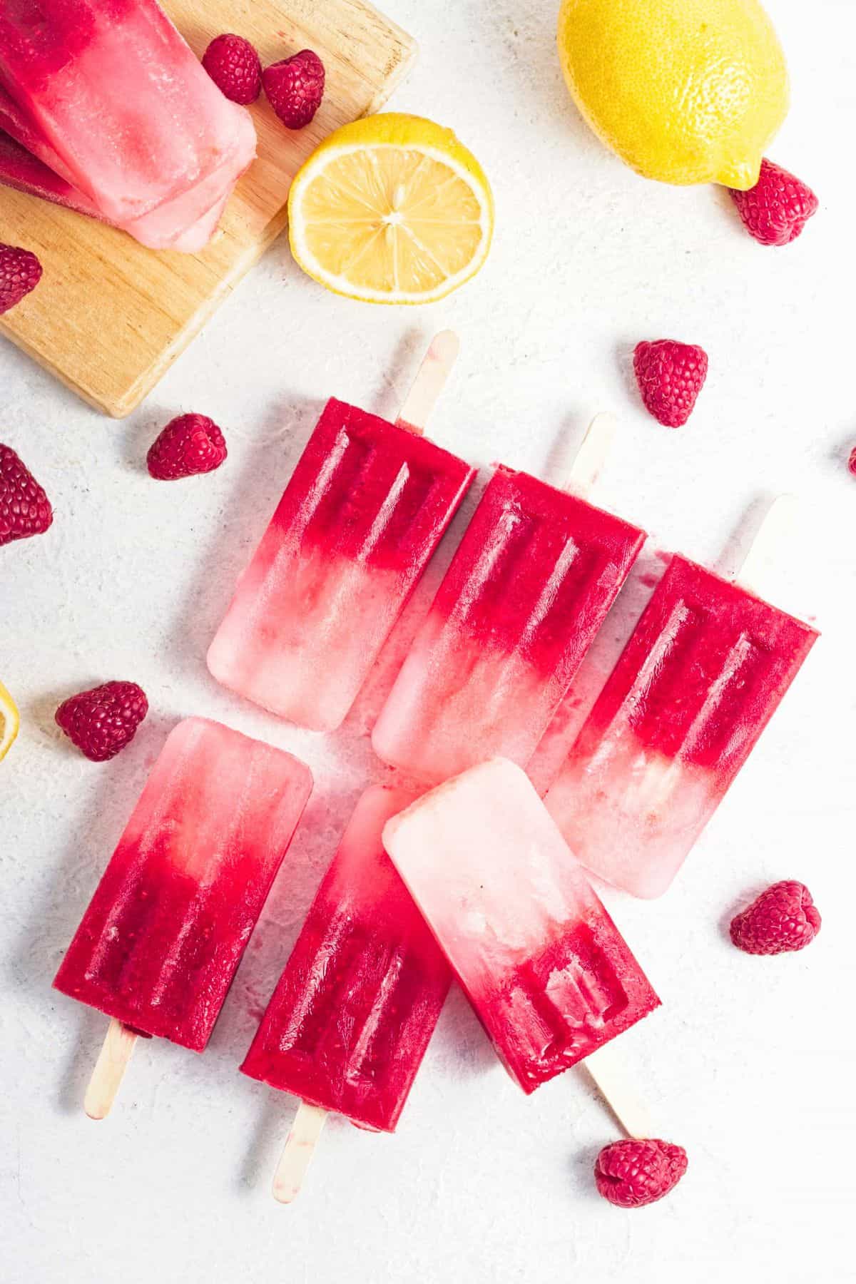 homemade raspberry popsicles lined up.