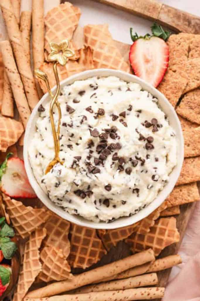 cannoli sweet dip in bowl surrounded by sweet wafers.