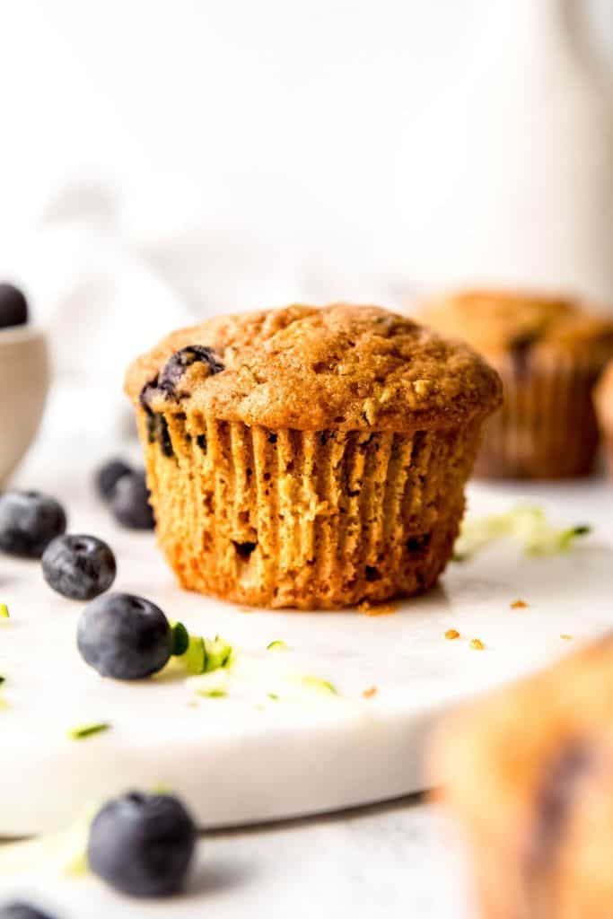 zucchini blueberry muffin on platter.