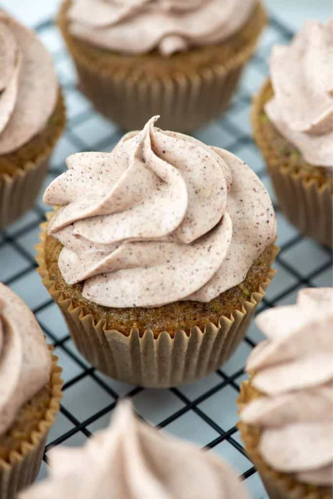 frosted zucchini cupcakes on wire rack.
