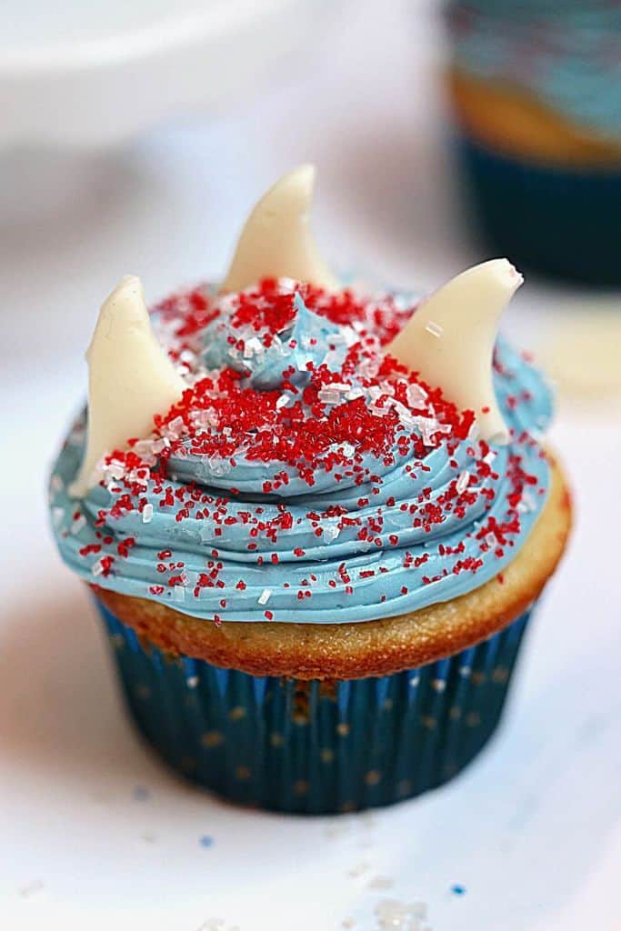 cute shark fin cupcake with blue frosting.