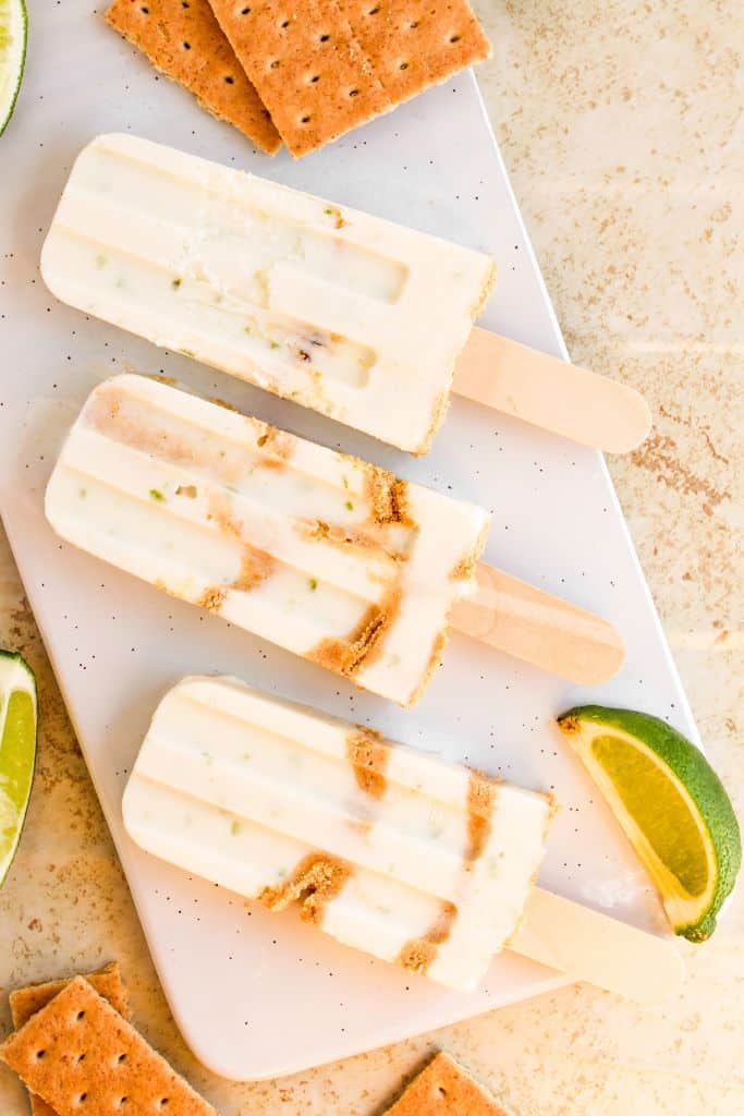 three key lime popsicles on platter.