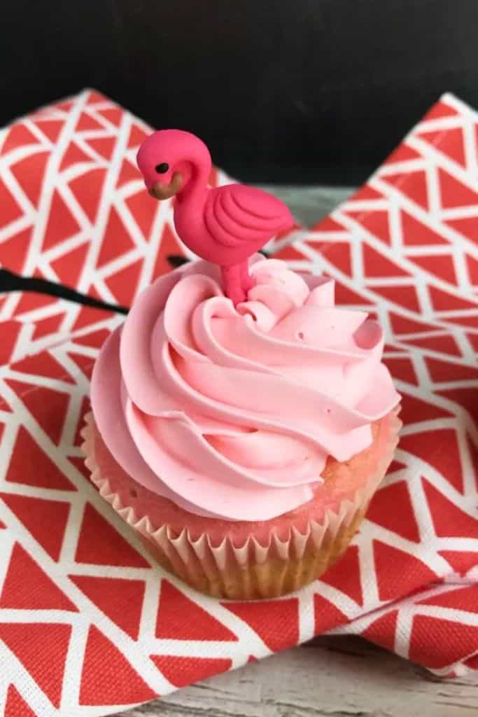 pink cupcake with pink flamingo on top.