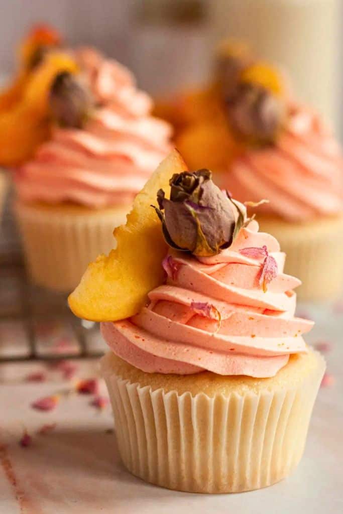 rose and peach flavored cupcake with pink frosting.