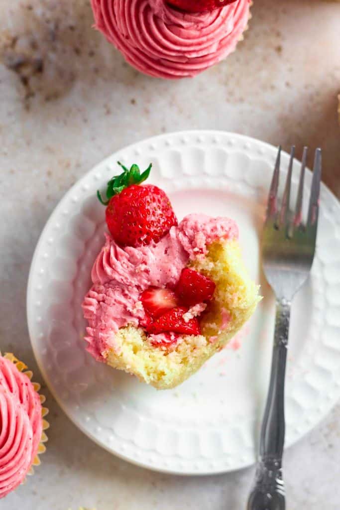 strawberry filled cupcake on plate.