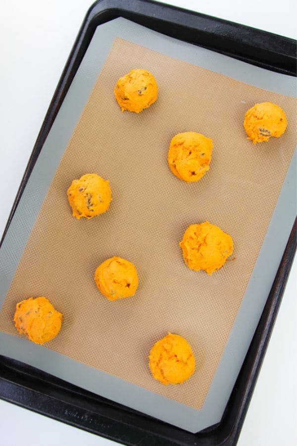 baked pumpkin cookies on silicon sheet.