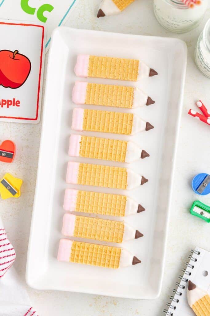 decorated pencil shaped cookies on tray.