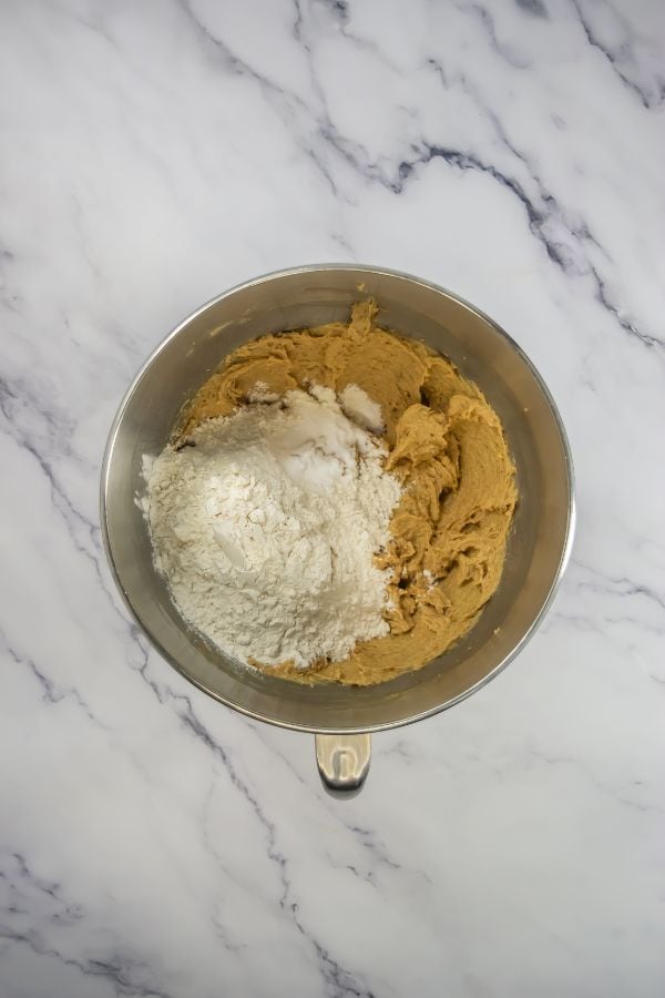 flour in bowl with cookie ingredients.