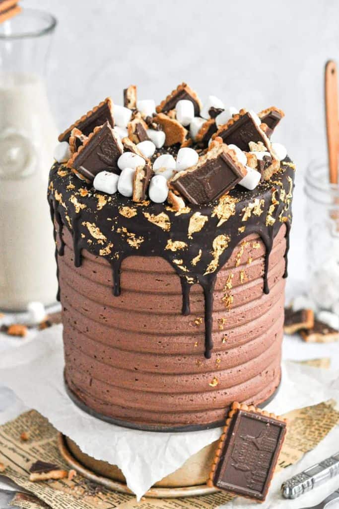 smores cake decorated with cookies and marshmallows.