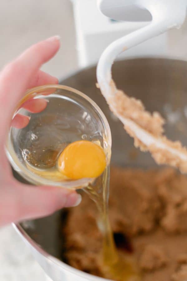 tipping egg into mixing bowl.