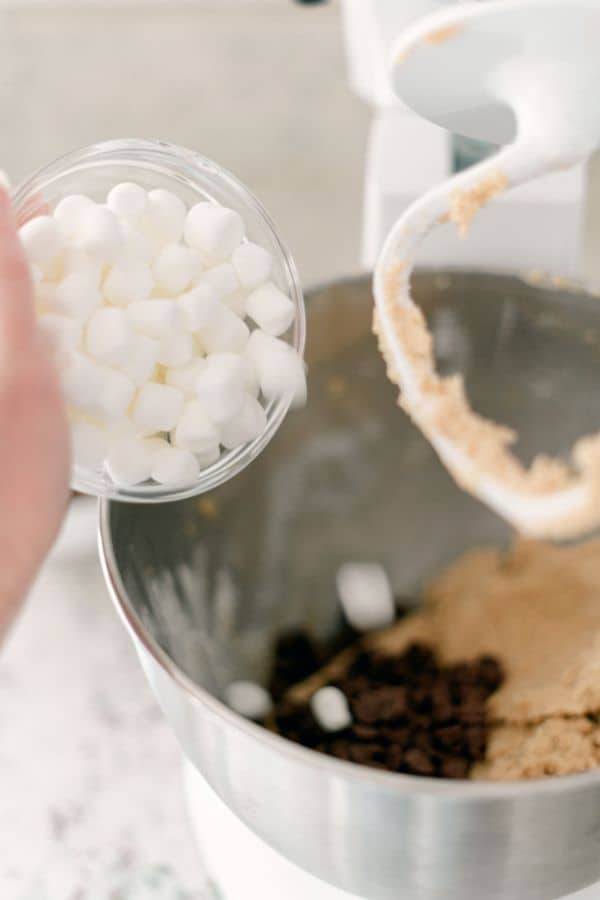 tipping mini marshmallows into mixing bowl.