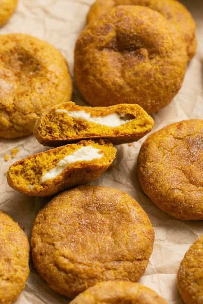 pumpkin cheesecake cookies on parchment paper.