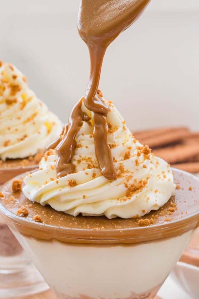 biscoff cheesecake in a cup topped with whipped cream.