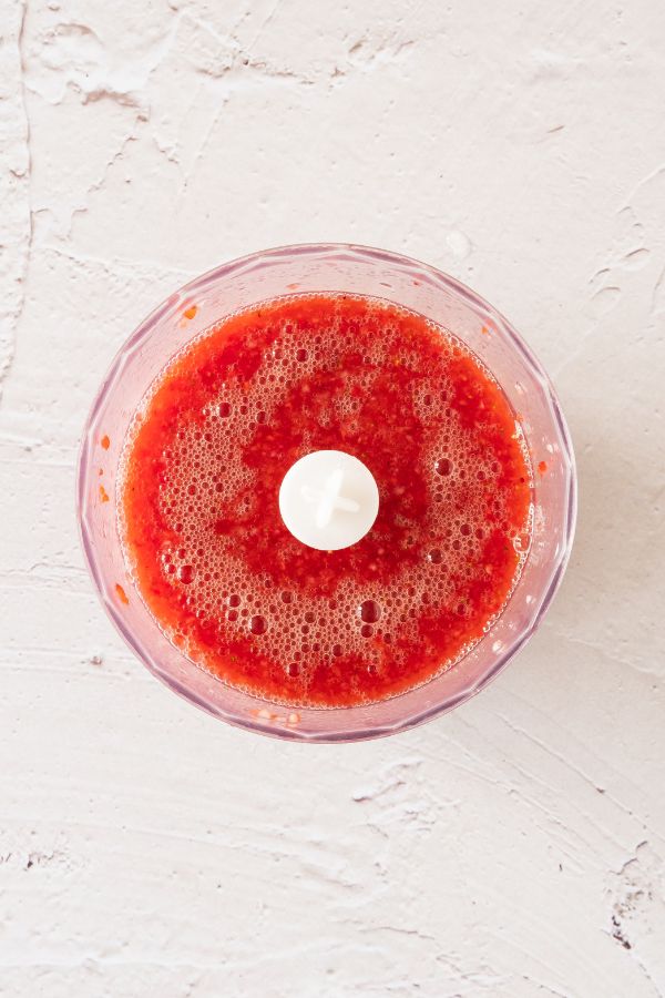 pureed strawberries in blender bowl.