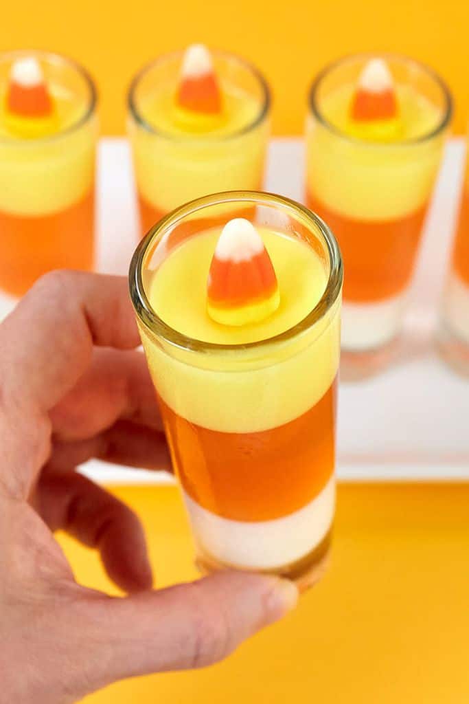candy corn jello shots in glasses.