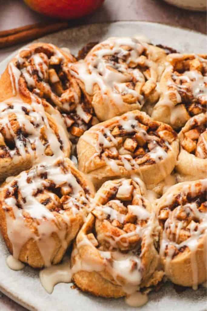 plate of apple cinnamon rolls with glaze.