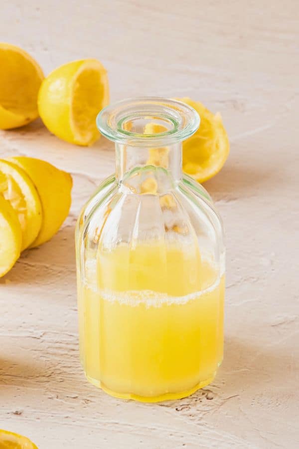 fresh lemon juice in glass bottle.