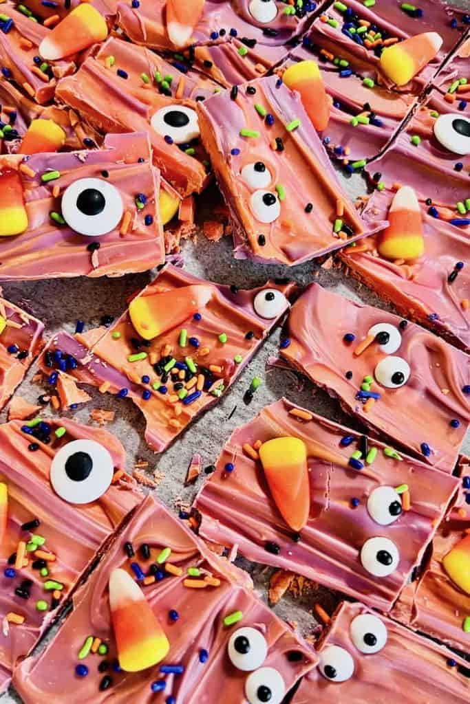 pieces of halloween candy bark with candy corn.