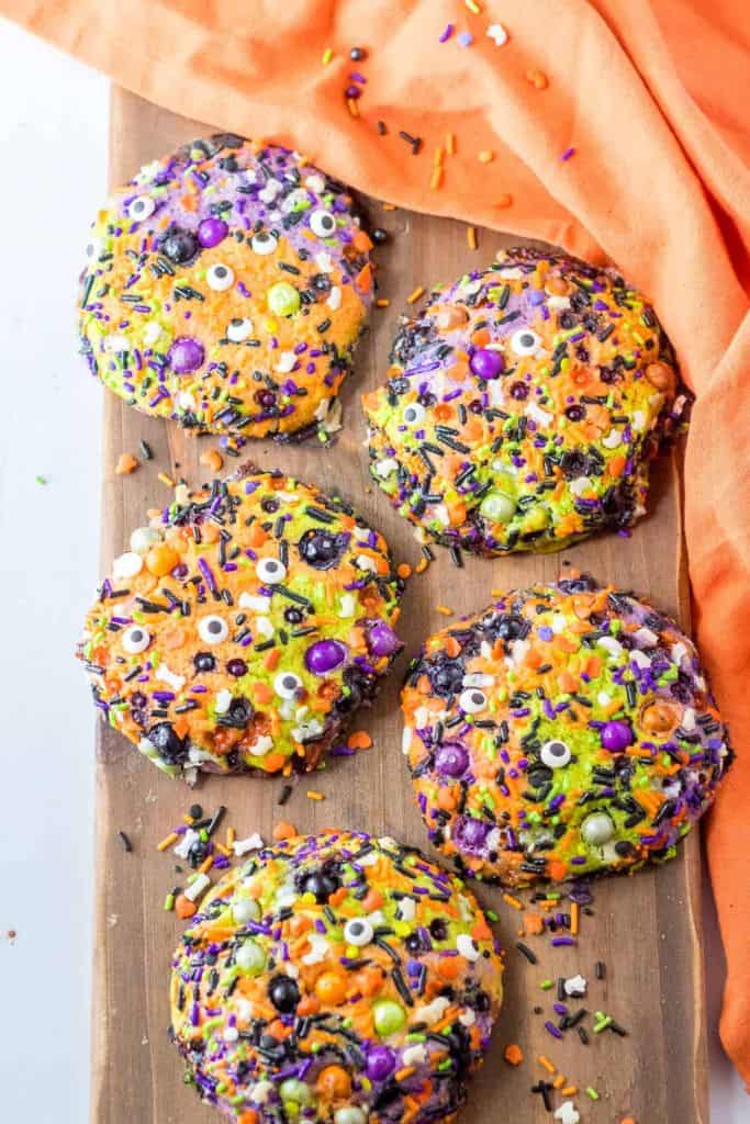 halloween sprinkle cookies on chopping board.