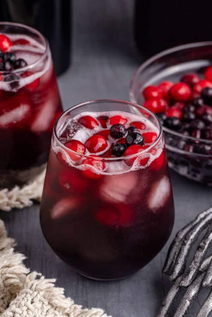 red sangria in glass with fruit.
