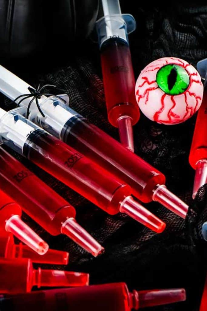 red jello shots in syringes.