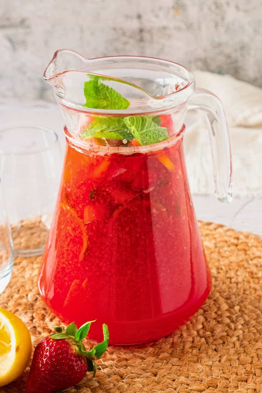 strawberry lemonade punch with mint in pitcher.