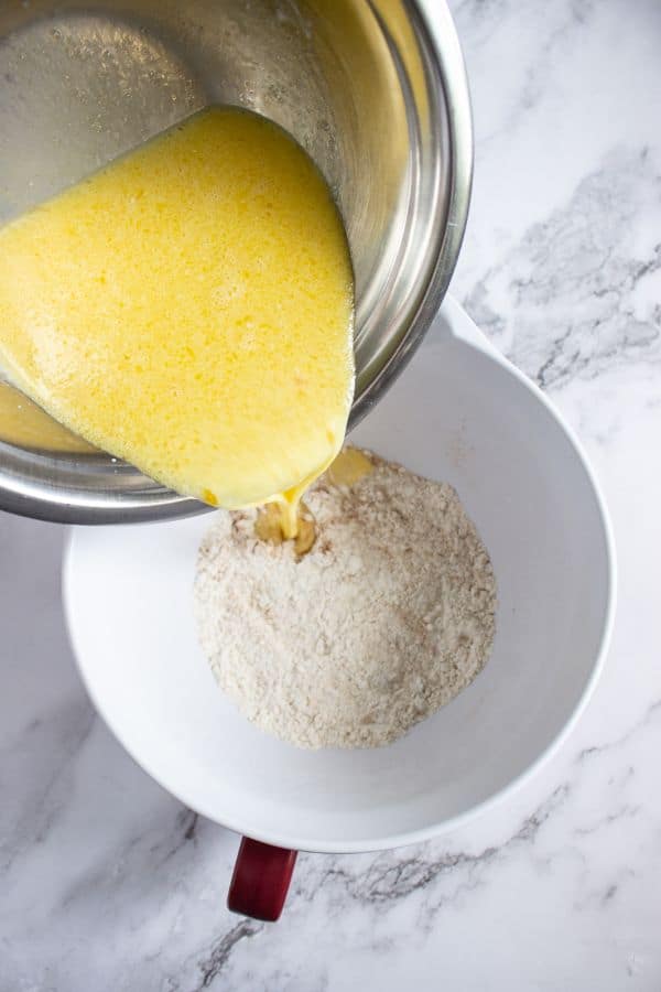 adding wet ingredients to dry ingredients in bowl.
