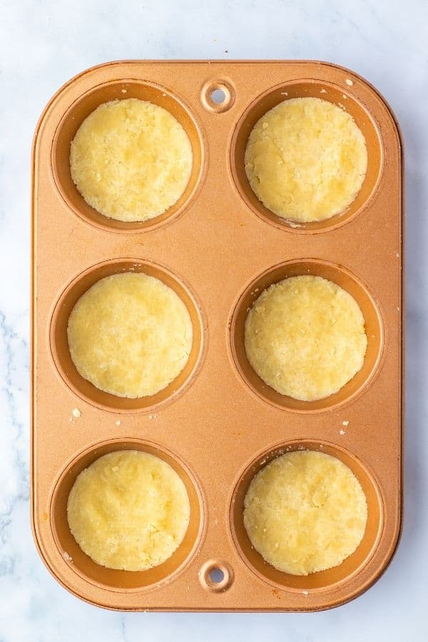shortcrust pastry in muffin tin holes.