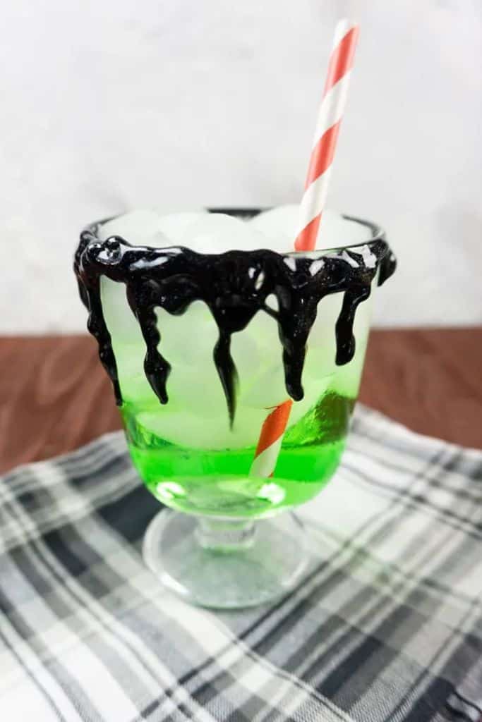 snow white poison apple drink with black rim and straw.