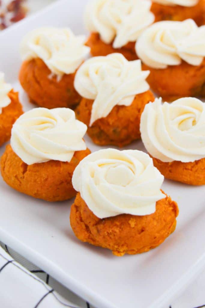 frosted pumpkin cake mix cookies on plate.