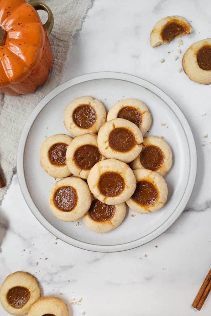pumpkin pie thumbprint cookies on plate.