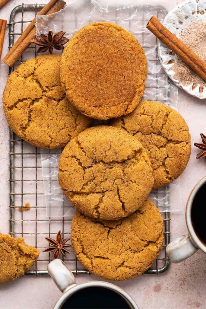 pumpkin snickerdoodle cookies on wire rack.