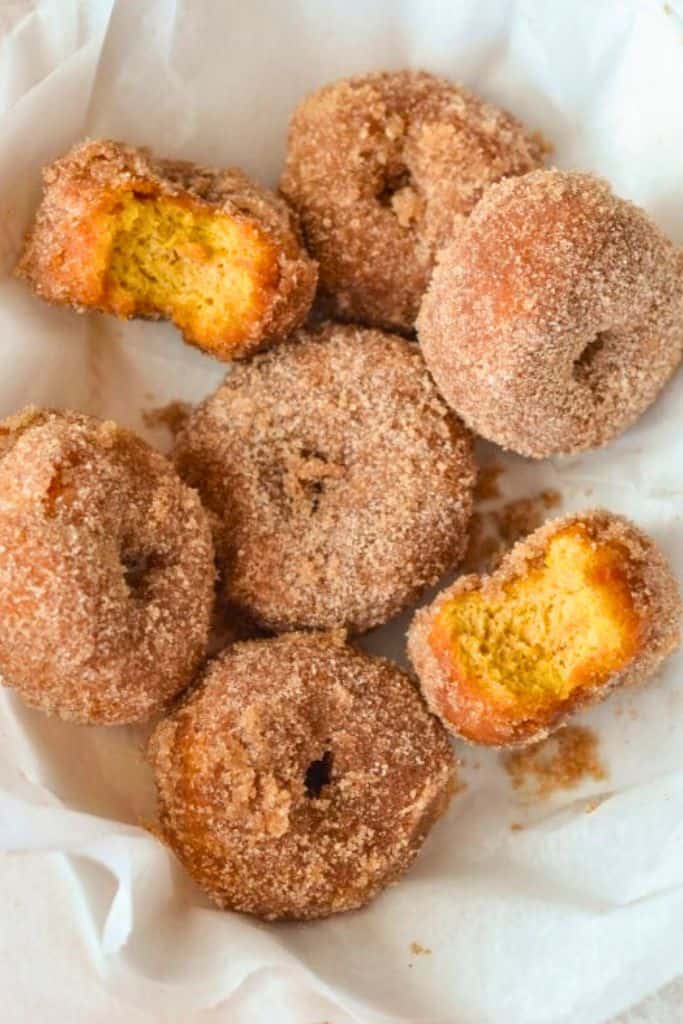sugar coated pumpkin donuts in basket.