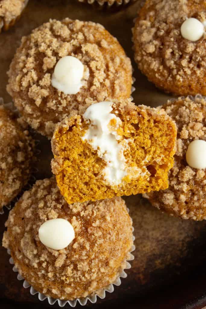 pile of pumpkin cream cheese muffins.