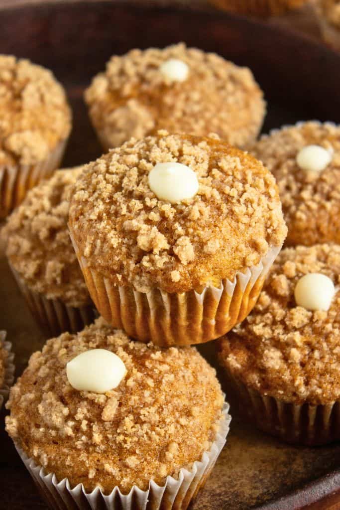 stack of pumpkin muffins with streusel topping.