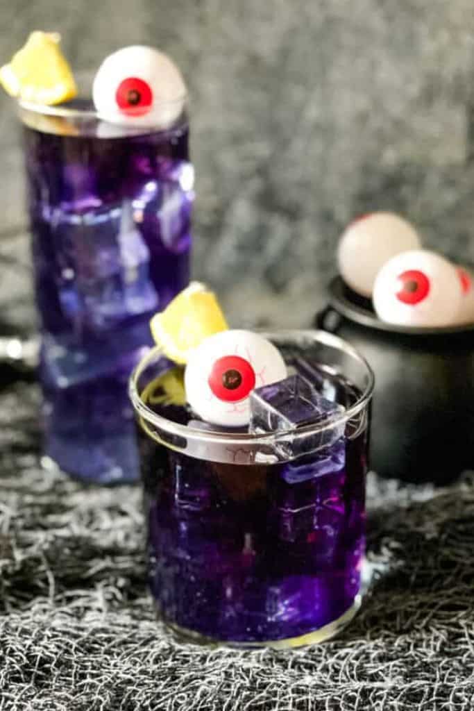 purple drink in glass with halloween eyeball.