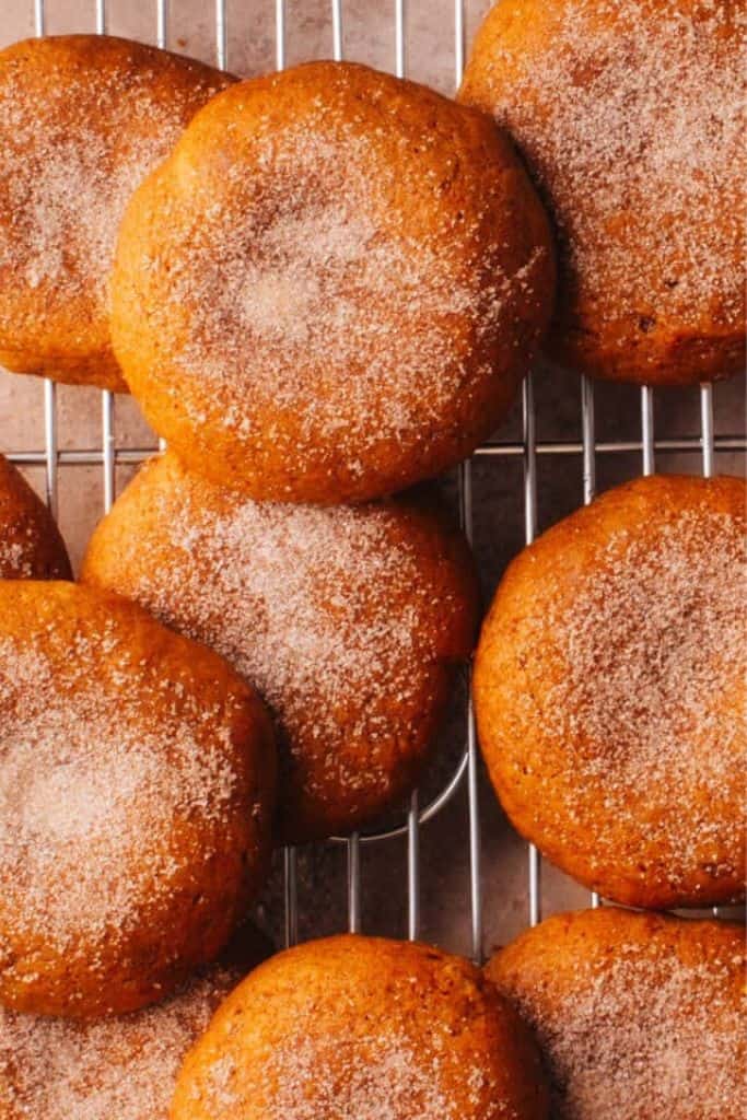 sugar dusted soft pumpkin cookies on rack.