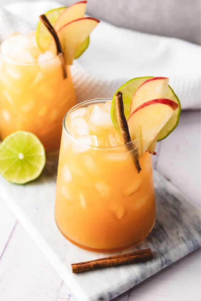 apple cider and ginger beer mocktail in glass with garnish.
