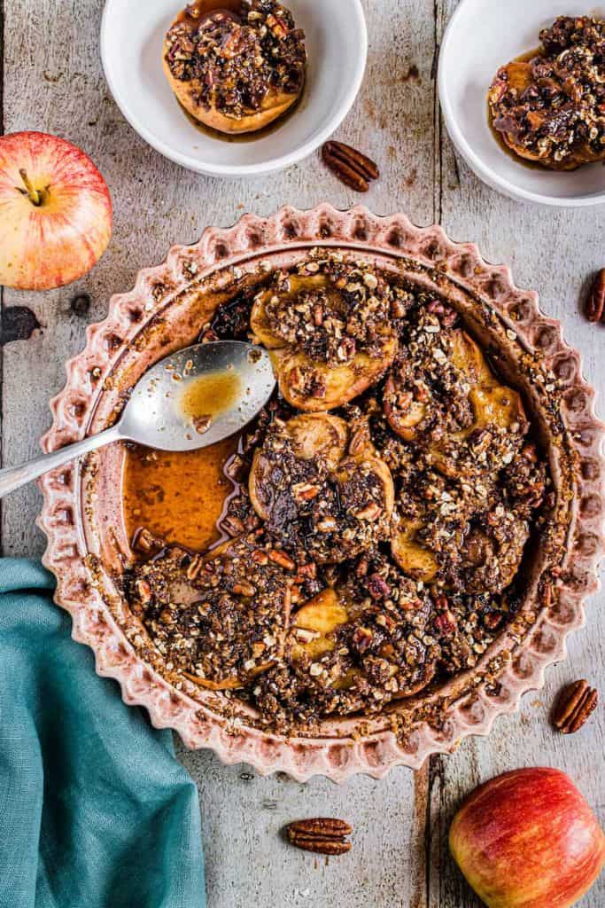 baked apples with pecan streusel in baking dish.