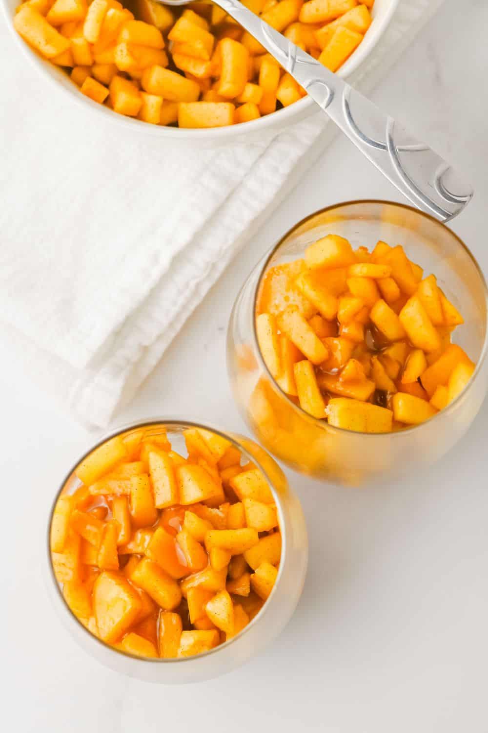 chopped caramel apple in glasses, top view.