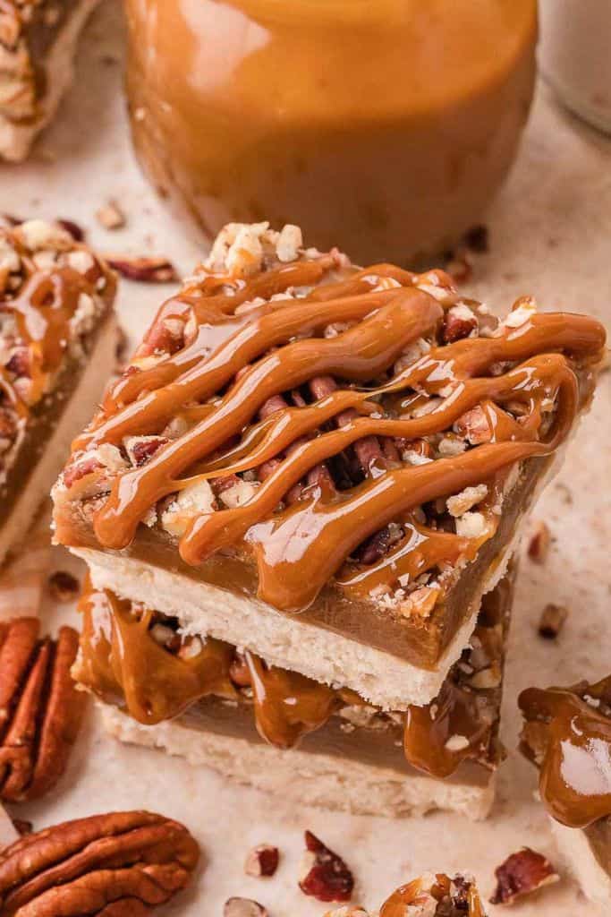 pecan bars drizzled with caramel sauce.