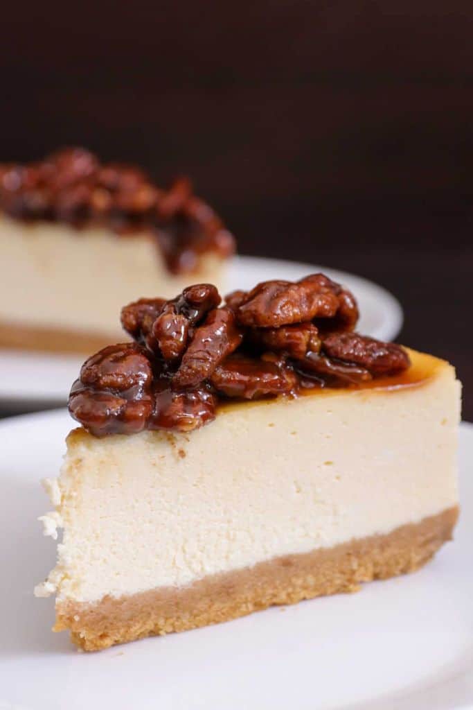 slice of caramel pecan cheesecake on plate.