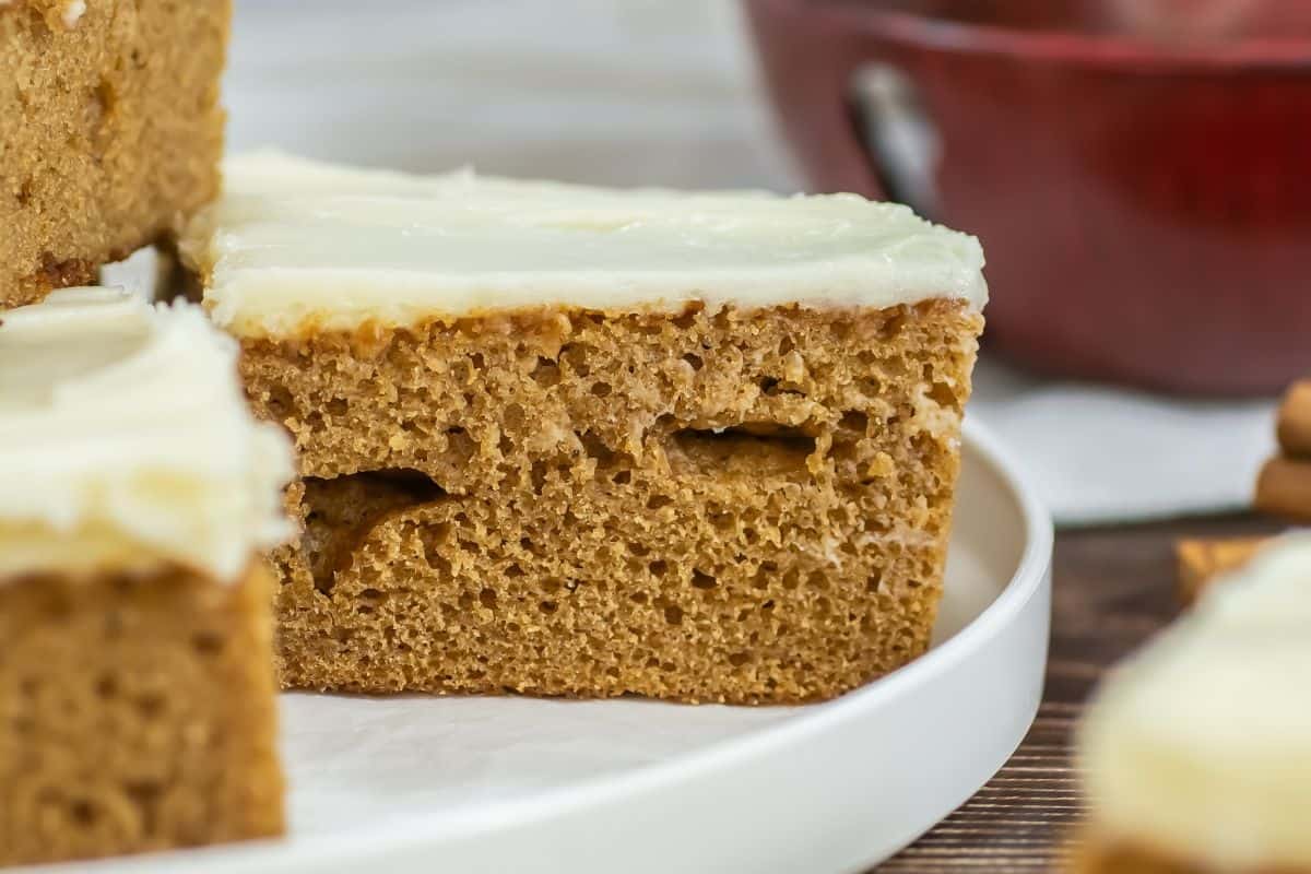 gingerbread cake with cream cheese frosting on plate.