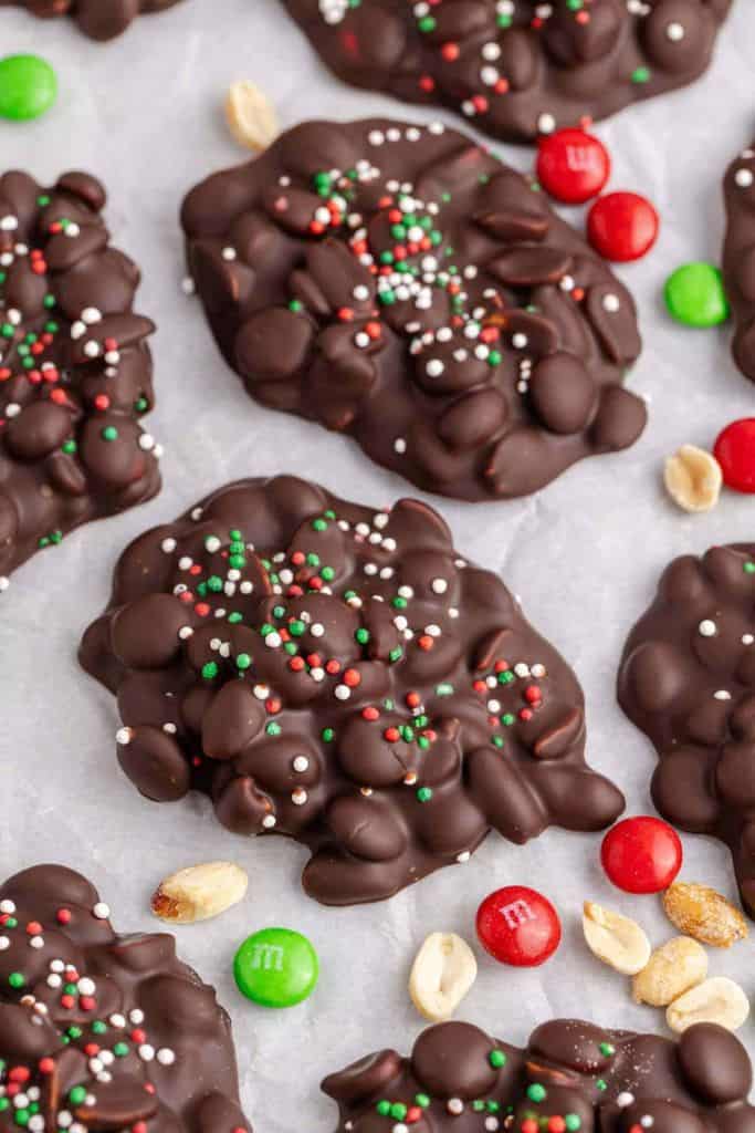 pieces of crockpot candy on parchment paper.