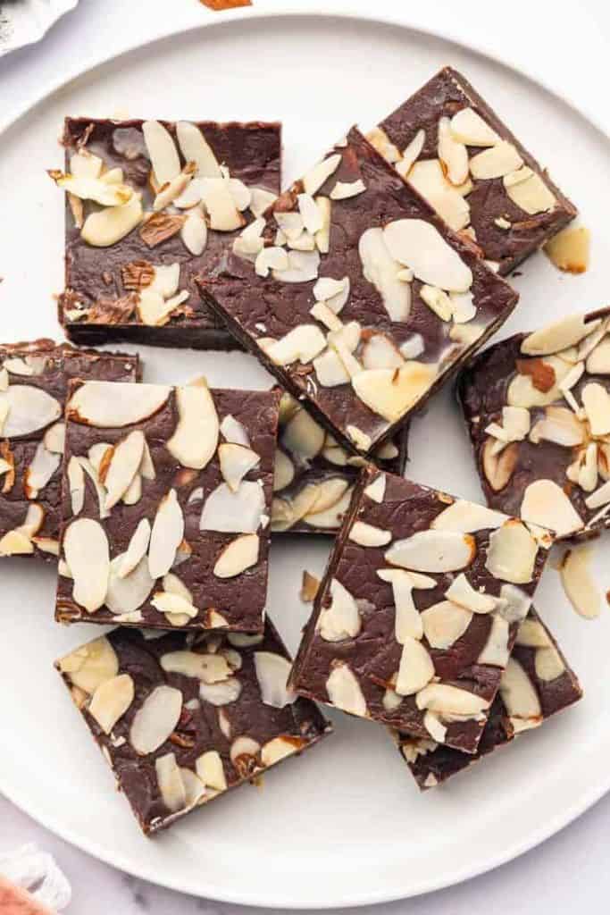chocolate fudge with almonds on plate.